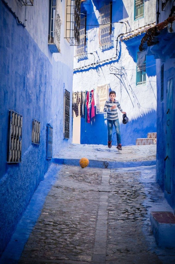 Genevieve Hathaway_Morocco_Chefchaouen_Boy playing soccer in the streets_edited
